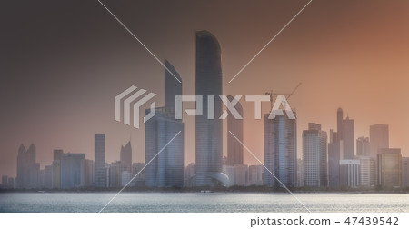View of Abu Dhabi Skyline at misty sunrise, UAE 47439542