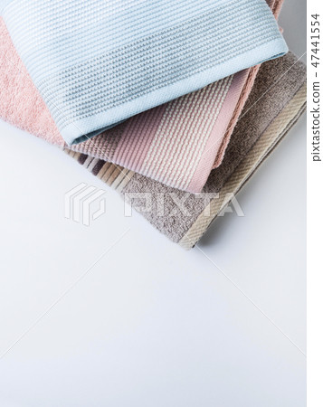 Pastel color clean folded towels on white Pastel color clean folded towels on white 47441554