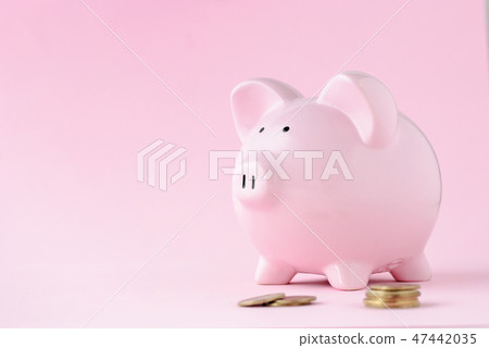Pink ceramic piggy bank over matching pink 47442035