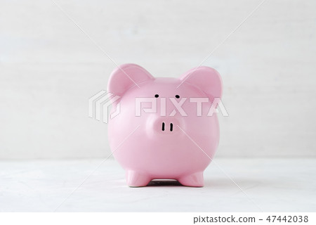 Pink piggy bank over a light off white background Pink piggy bank over a light off white background 47442038