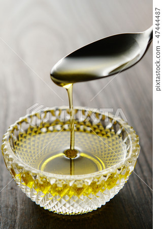 Olive oil dripping from the spoon Olive oil dripping from the spoon 47444487