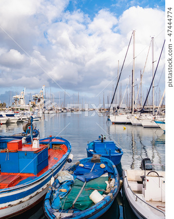 A scene of a marina in Palermo, with yachts and fishing boats lined up on the sea. A scene of a marina in Palermo, with yachts and fishing boats lined up on the sea. 47444774