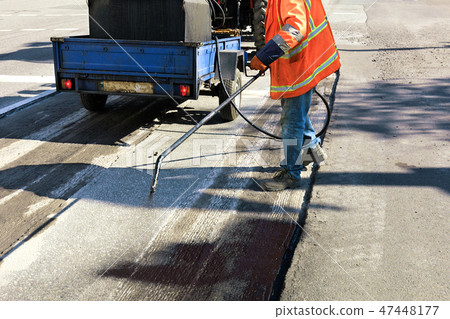 Partial repair of the asphalt road. Partial repair of the asphalt road. 47448177