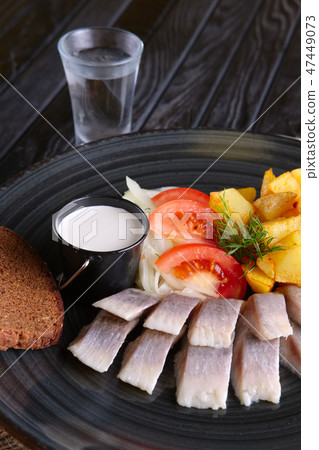Snack for vodka - pickled herring, fried potato 47449073