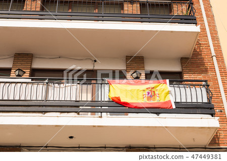 Flag of Spain hanging on the balcony of a house 47449381