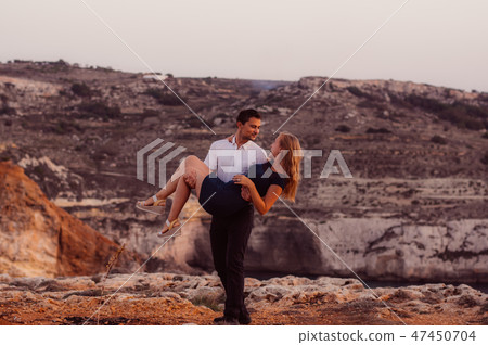 Man carry on hands woman in the evening Man carry on hands woman in the evening 47450704