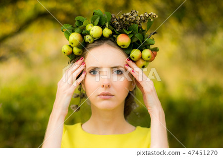Portrait of young woman in apple garden Portrait of young woman in apple garden 47451270