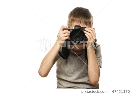 Boy takes pictures on camera. Portrait. Isolate Boy takes pictures on camera. Portrait. Isolate 47451370