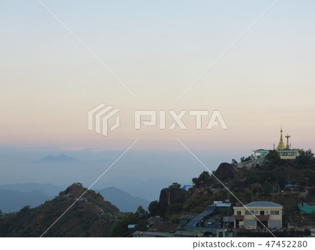 Colorful morning sky with golden pagoda on hil 47452280