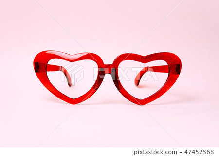 A pair of red heart shaped sun glasses. A pair of red heart shaped sun glasses. 47452568