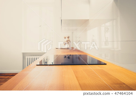 wooden worktop and cooktop closeup  in  kitchen  47464104
