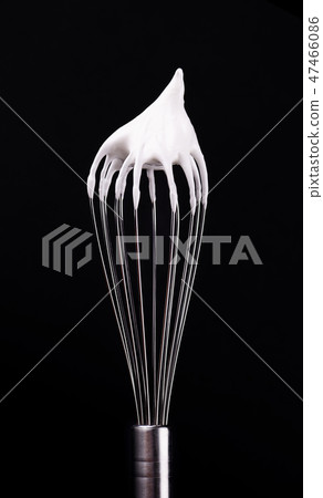 Metal whisk with whipped egg whites, isolated on black background. Clipping path. Metal whisk with whipped egg whites, isolated on black background. Clipping path. 47466086
