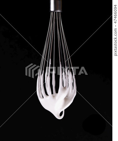 Metal whisk with whipped egg whites, isolated on black background. Clipping path. Metal whisk with whipped egg whites, isolated on black background. Clipping path. 47466094