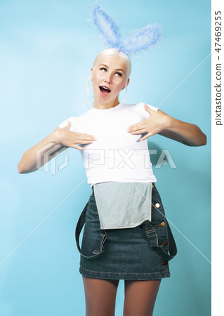 young pretty blond girl with rabbit ears posing cheerful on blue background, lifestyle people young pretty blond girl with rabbit ears posing cheerful on blue background, lifestyle people 47469255