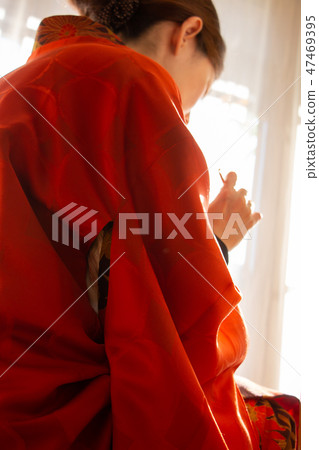 A woman wearing a woman wearing a red kimono Kimono A woman wearing a woman wearing a red kimono Kimono 47469395