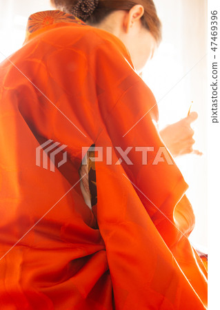 A woman wearing a woman wearing a red kimono Kimono A woman wearing a woman wearing a red kimono Kimono 47469396