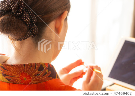 A woman wearing a woman wearing a red kimono Kimono A woman wearing a woman wearing a red kimono Kimono 47469402