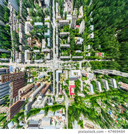 Aerial city view with crossroads and roads, houses, buildings, parks and parking lots. Sunny summer 47469484