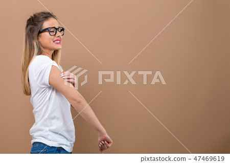 Young woman scratching her itchy arm. Young woman scratching her itchy arm. 47469619