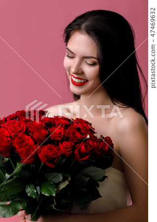 beautiful young woman with a large bouquet of red roses beautiful young woman with a large bouquet of red roses 47469632