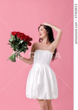 beautiful young woman with a large bouquet of red roses beautiful young woman with a large bouquet of red roses 47469655