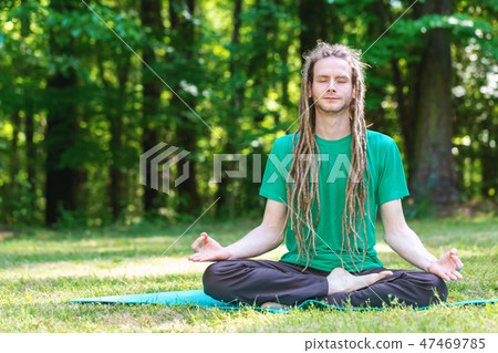 Man in a meditation pose outside Man in a meditation pose outside 47469785