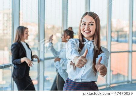 Face of a handsome young cheerful smiling business woman. Showing a gesture class against the Face of a handsome young cheerful smiling business woman. Showing a gesture class against the 47470029