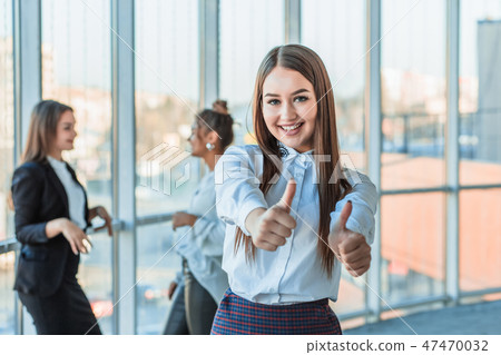 Face of a handsome young cheerful smiling business woman. Showing a gesture class against the Face of a handsome young cheerful smiling business woman. Showing a gesture class against the 47470032