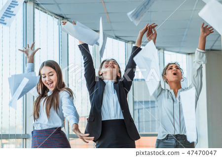 Three young beautiful brunette business ladies in the office. All happy dancing dancing up the Three young beautiful brunette business ladies in the office. All happy dancing dancing up the 47470047