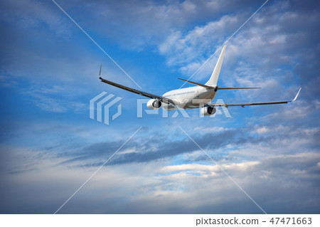 Aircraft is flying in blue cloudy sky 47471663