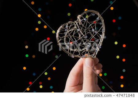 Heart shaped metal cage on bokeh light background Heart shaped metal cage on bokeh light background 47471848