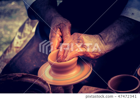 Potter`s hands shaping up the clay Potter`s hands shaping up the clay 47472341