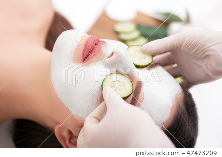 Spa concept. Young woman with nutrient facial mask in beauty salon, close up Spa concept. Young woman with nutrient facial mask in beauty salon, close up 47473209
