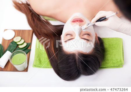 Hardware cosmetology. Closeup picture of lovely young woman with cream mask in a beauty parlour. Hardware cosmetology. Closeup picture of lovely young woman with cream mask in a beauty parlour. 47473264