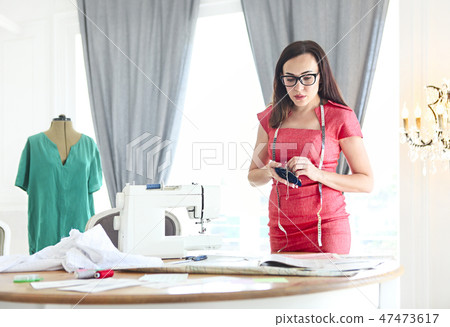 Fashion designer woman working on her designs 47473617