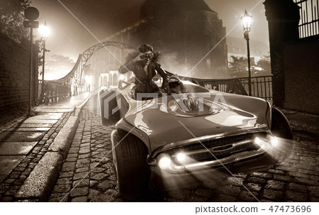 Alluring female driver in retro car 47473696