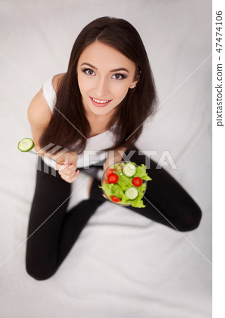 Diet. The concept of healthy and unhealthy nutrition. The model plus size makes a choice in favor of 47474106