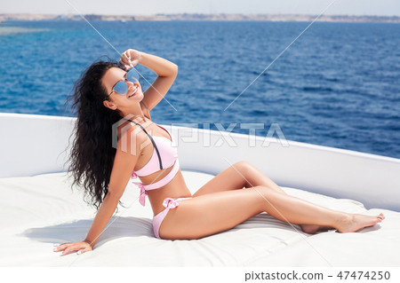 Woman on a Yacht in the Sea. Luxury vacation on a boat near the islands in the summer. Beautiful 47474250