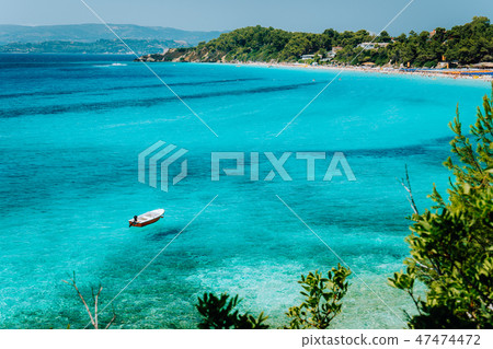 Pleasure white boat in crystal clear blue sea water. Spectacular Platis Gialos and Makris Gialos Pleasure white boat in crystal clear blue sea water. Spectacular Platis Gialos and Makris Gialos 47474472