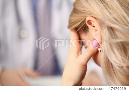 Young male doctor holds sick patient by hand 47474939
