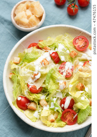 Caesar salad with sauce on plate, top view Caesar salad with sauce on plate, top view 47476155
