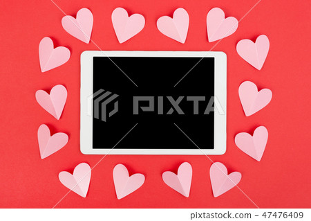 Valentine's Day background with touchpad and paper hearts. Flat lay. 47476409