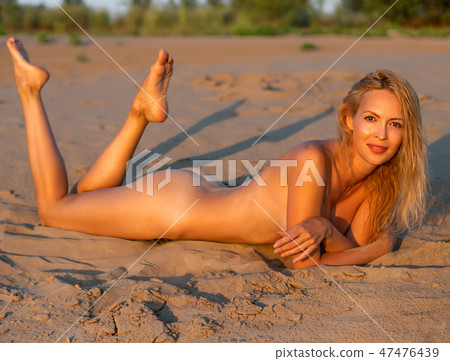 Beautiful girl model on sandy beach of the sea Beautiful girl model on sandy beach of the sea 47476439