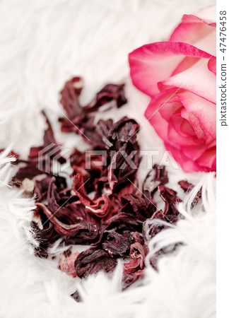 Dry hibiscus tea and a lively pink rose 47476458