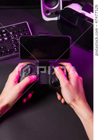Man hands playing a computer game with a game joystick. 47477526