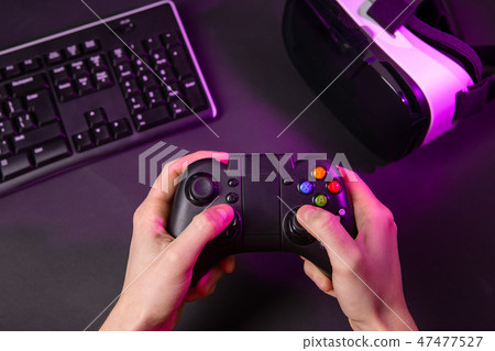 Man hands playing a computer game with a game joystick. 47477527
