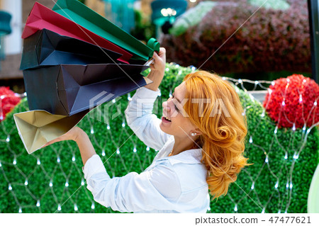 Young Women with Packages Shopping in Modern Mall. Shopping Concept. Black Friday Concept. Happy Young Women with Packages Shopping in Modern Mall. Shopping Concept. Black Friday Concept. Happy 47477621