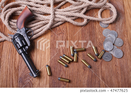 Wild west gun, ammunition and silver dollars Wild west gun, ammunition and silver dollars 47477625