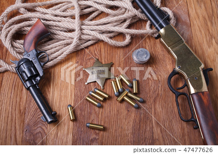 Wild west rifle, ammunition and sheriff badge Wild west rifle, ammunition and sheriff badge 47477626