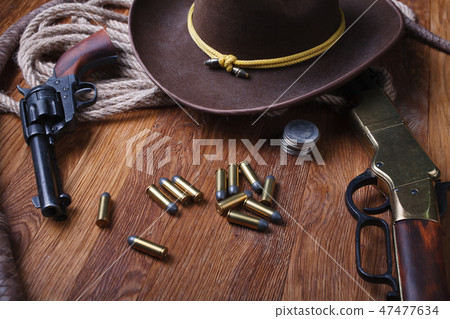 Wild west guns, ammunition and silver dollars Wild west guns, ammunition and silver dollars 47477634